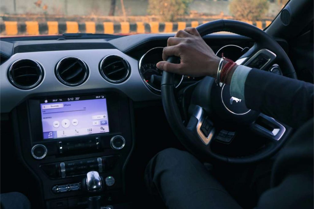 a Man driving on a highway during daytime, capturing road trip mood.